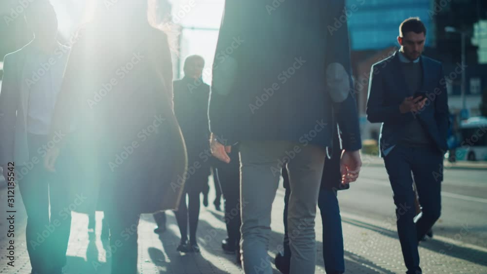 Diverse and Multicultural Office Managers and Business People Commute to Work in the Morning or from Office on a Cloudy Day on Foot. Pedestrians are Smart Casually Dressed. People Using Smartphones.