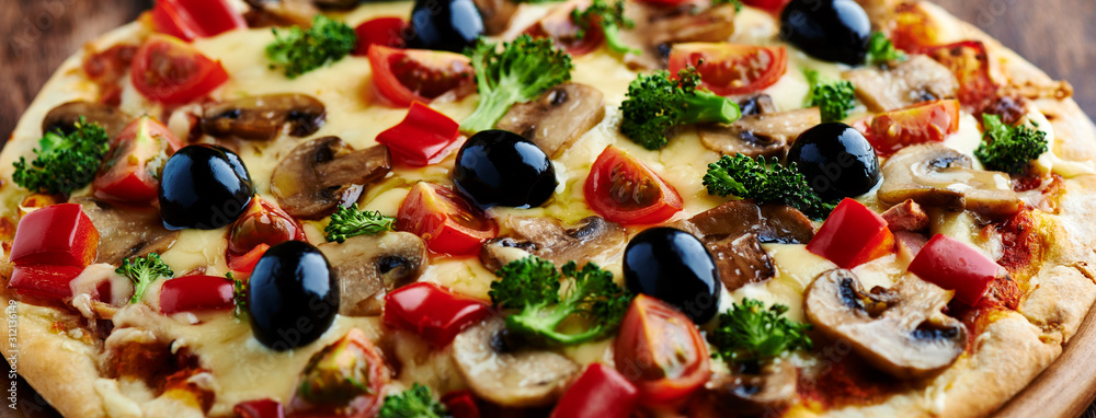 Healthy pizza with broccoli, cherry tomatoes, red pepper and champignon mushrooms. Close up. Healthy pizza with broccoli, cherry tomatoes, red pepper and champignon mushrooms. Close up.