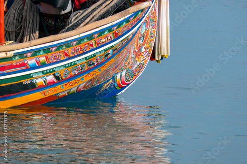 Pattern drawn on the folk fishing boat of Pattani province. The traditional fishing boat of Pattani Province is unique, which is painted with beautiful patterns. photo