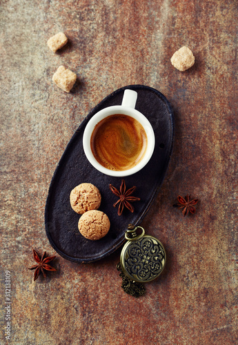 Cup of coffee and amaretti cookies on rustic background. Top view. Copy space.