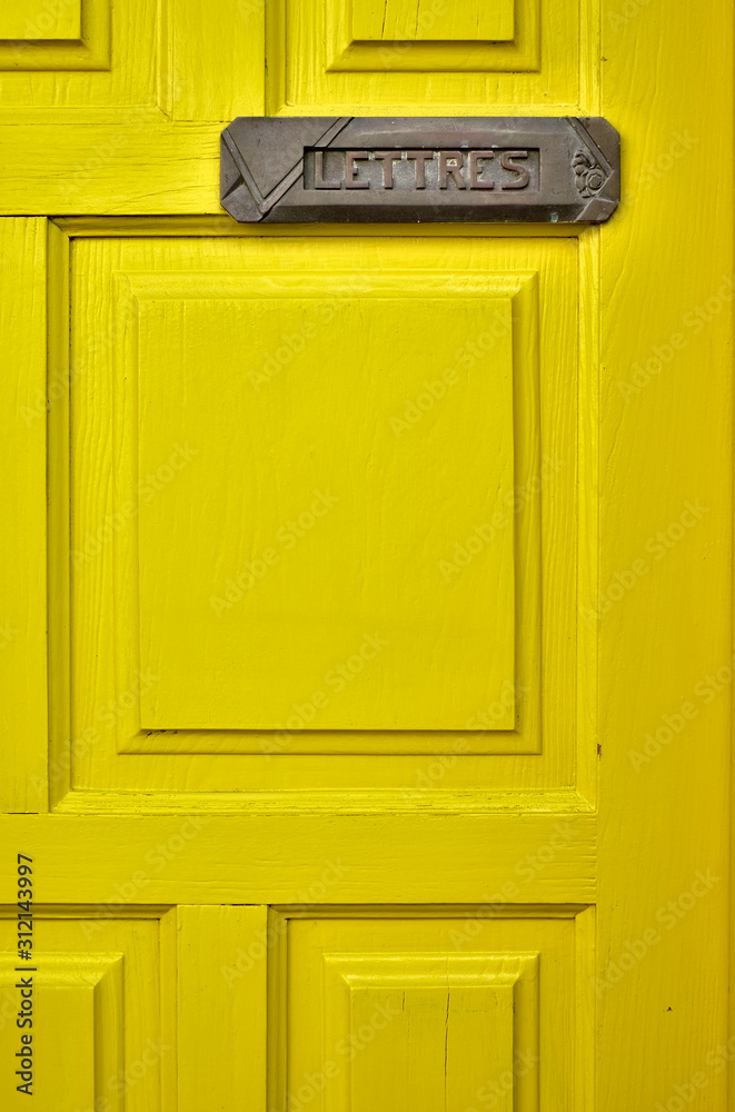 Lemon yellow door with a letter box and a French word LETTRES (English: MAIL). Lemon yellow door with a letter box and a French word LETTRES (English: MAIL).
