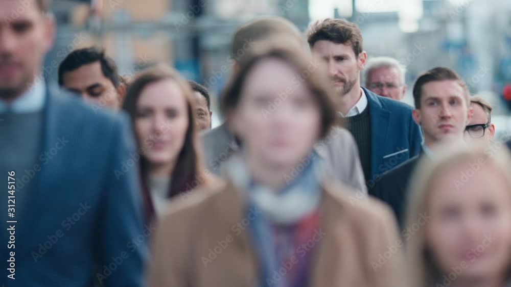 Diverse and Multicultural Office Managers and Business People Commute to Work in the Morning or from Office on Foot. Pedestrians are Dressed Smartly. Successful People Walking in Downtown. Diverse and Multicultural Office Managers and Business People Commute to Work in the Morning or from Office on Foot. Pedestrians are Dressed Smartly. Successful People Walking in Downtown.