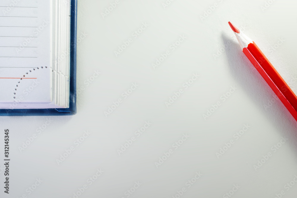 corner of blue Notepad and red pencil corner of blue Notepad and red pencil