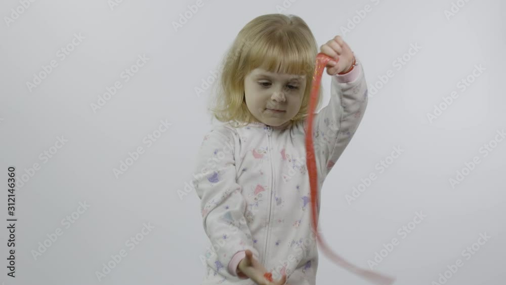 Kid playing with hand made toy slime. Child having fun making pink slime Kid playing with hand made toy slime. Child having fun making pink slime