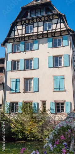White timber framed house with blue shutters in Strasbourg, France © Heather