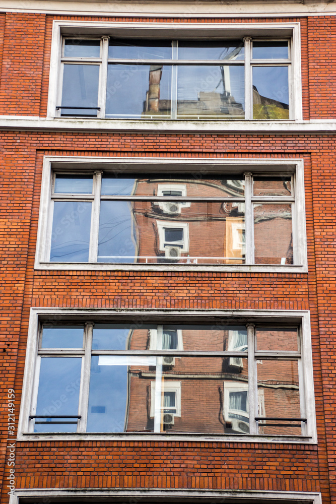 Brick building reflection on windows