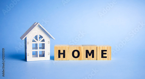 Stock word home spelled on alphabet wooden block letters on old weathered wood blocks over blue, home concept