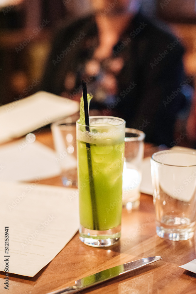 Close up of a green cocktail on a table Close up of a green cocktail on a table