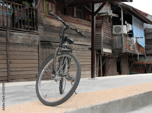 Vintage bicycle in front of the old community in thailand