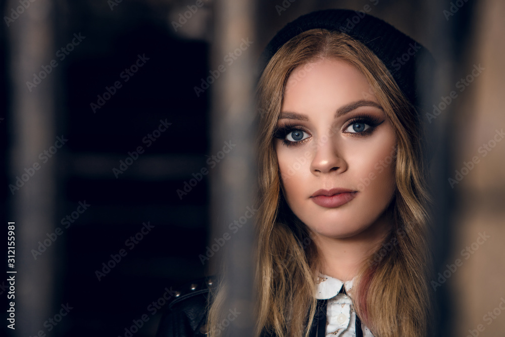 beautiful girls face through bars in an old archway beautiful girls face through bars in an old archway