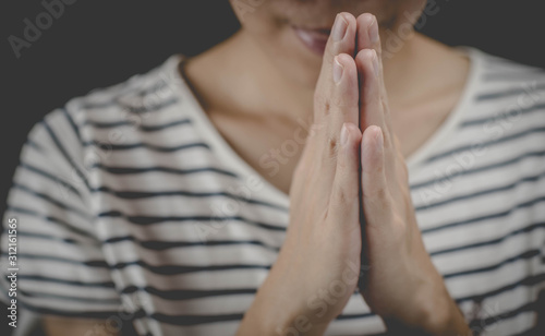A woman is praying by her hands. Praying hands.
