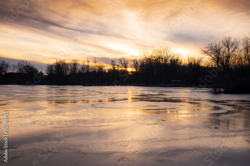 Sunset on a frozen Reeds Lake in Grand Rapids  Michigan.