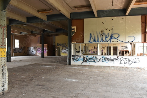 Schilderij op canvas Abandoned Power Station with unsettling graffiti