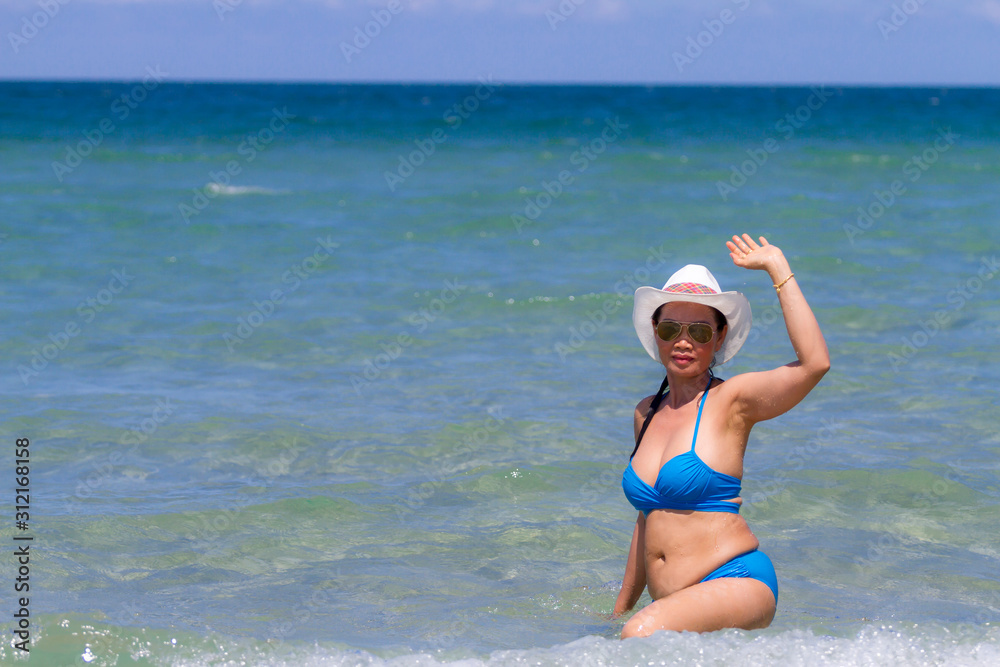 Woman and bikini blue relax in water at Ban Krut Beach,