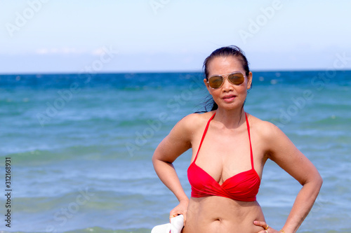 Woman shape huge with red bikini enjoy on beach