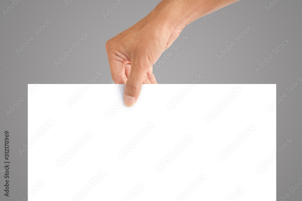 hand holding blank sheet of white paper isolated on gray with copy space for text and picture hand holding blank sheet of white paper isolated on gray with copy space for text and picture