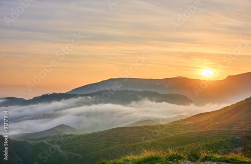 Beautiful Sunrise over Clouds and Mountains