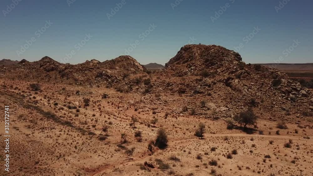 4K aerial drone video of gravel plains and granite rock formations near town Karasburg, B1 highway in the south of Namibia and dry waterless hot bush savanna in Grunau District, southern Africa 4K aerial drone video of gravel plains and granite rock formations near town Karasburg, B1 highway in the south of Namibia and dry waterless hot bush savanna in Grunau District, southern Africa