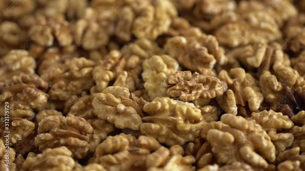 Walnut close up. product rich in minerals and vitamins. Walnut turns in a shot. Walnut kernels rotating. walnut close up lies under beams of the sun. Macro Walnut close up. product rich in minerals and vitamins. Walnut turns in a shot. Walnut kernels rotating. walnut close up lies under beams of the sun. Macro