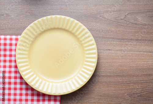 Food background with empty plate and red kitchen towel on wood
