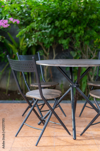 Metal chairs and table in gazebo on backyard