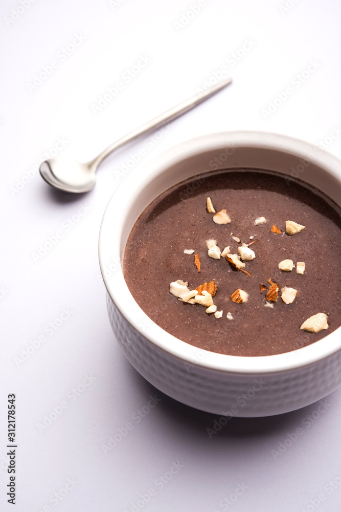 Sweet Ragi Malt / Healthy Ragi Porridge in a bowl garnished with crushed dry fruits