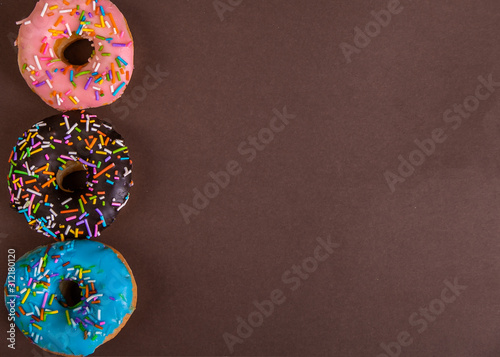 colorful doughnuts brown background studio