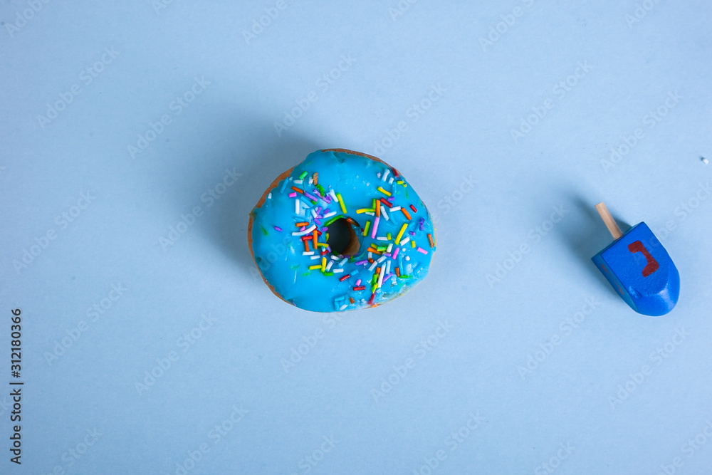 Obraz na plátně colorful doughnut dreidel blue background studio