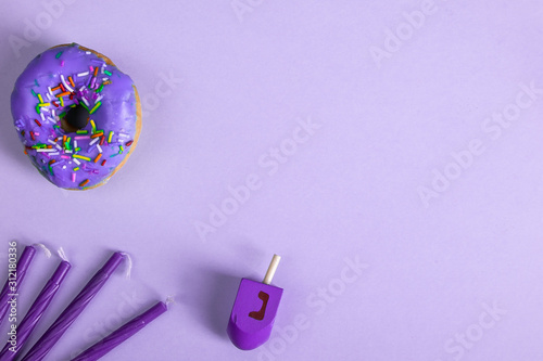 colorful doughnut dreidel candles purple background studio