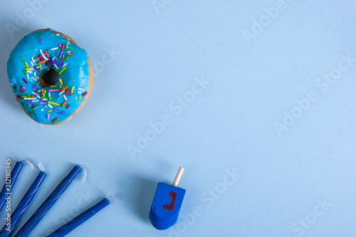 colorful doughnut dreidel candels blue background studio