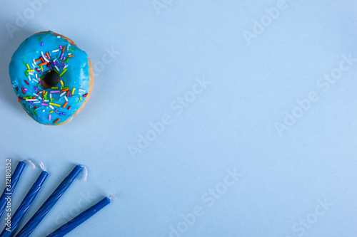 colorful doughnut dreidel candels blue background studio