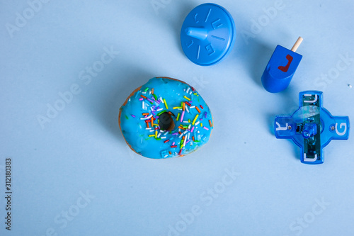 colorful doughnut dreidel blue background studio