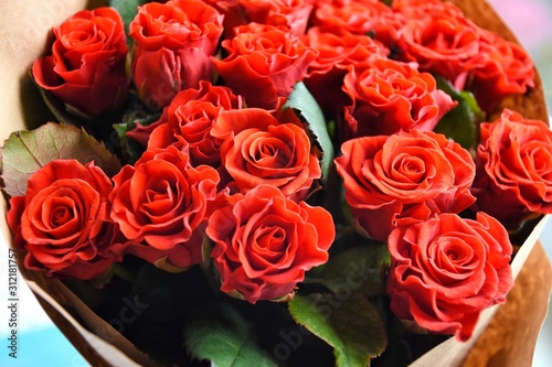 Red roses background. beautiful lush lava roses with selective focus in craft paper. St valentines bouquet made of amazing red roses. Bouquet of red roses. Present for Mother   s Day. St Valentine   s Day