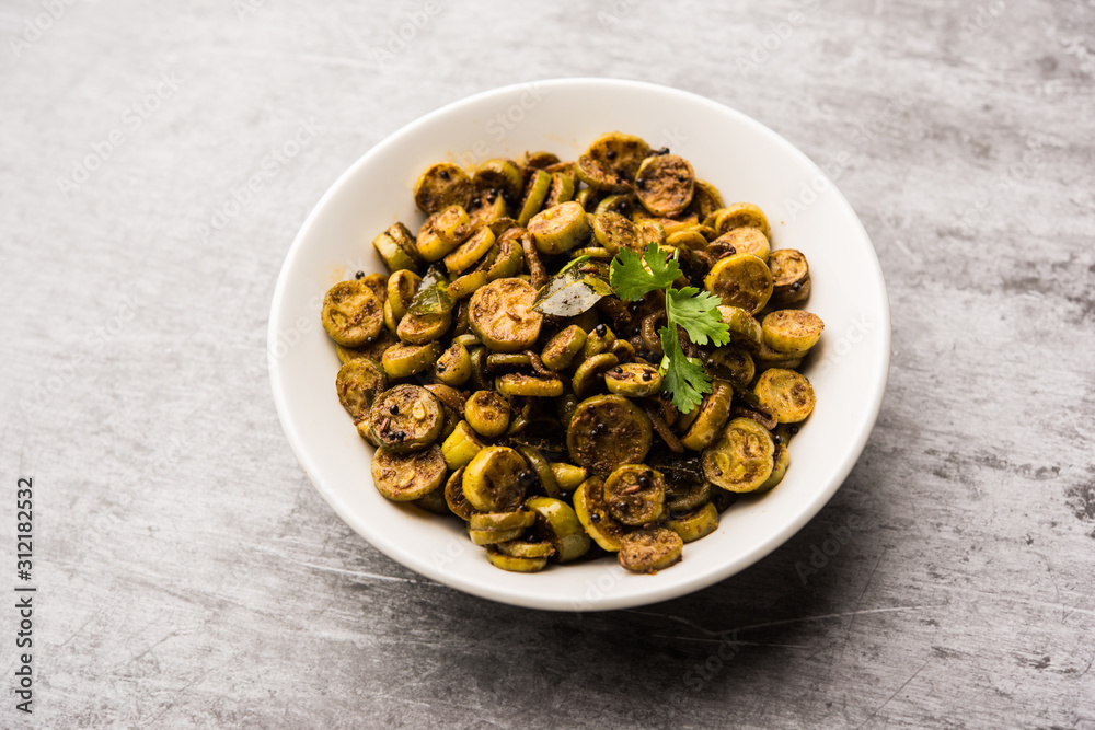 Tendli / Kundroo sabzi or Kovakkai Poriyal also known as ivy gourd, served in a bowl or karahi. selective focus Tendli / Kundroo sabzi or Kovakkai Poriyal also known as ivy gourd, served in a bowl or karahi. selective focus