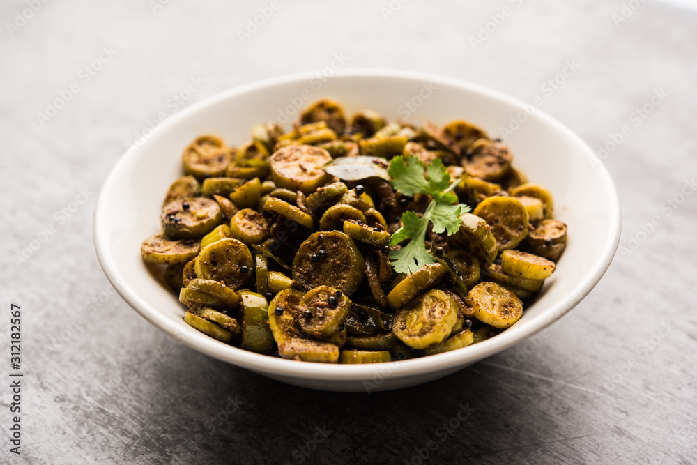 Tendli / Kundroo sabzi or Kovakkai Poriyal also known as ivy gourd, served in a bowl or karahi. selective focus Tendli / Kundroo sabzi or Kovakkai Poriyal also known as ivy gourd, served in a bowl or karahi. selective focus