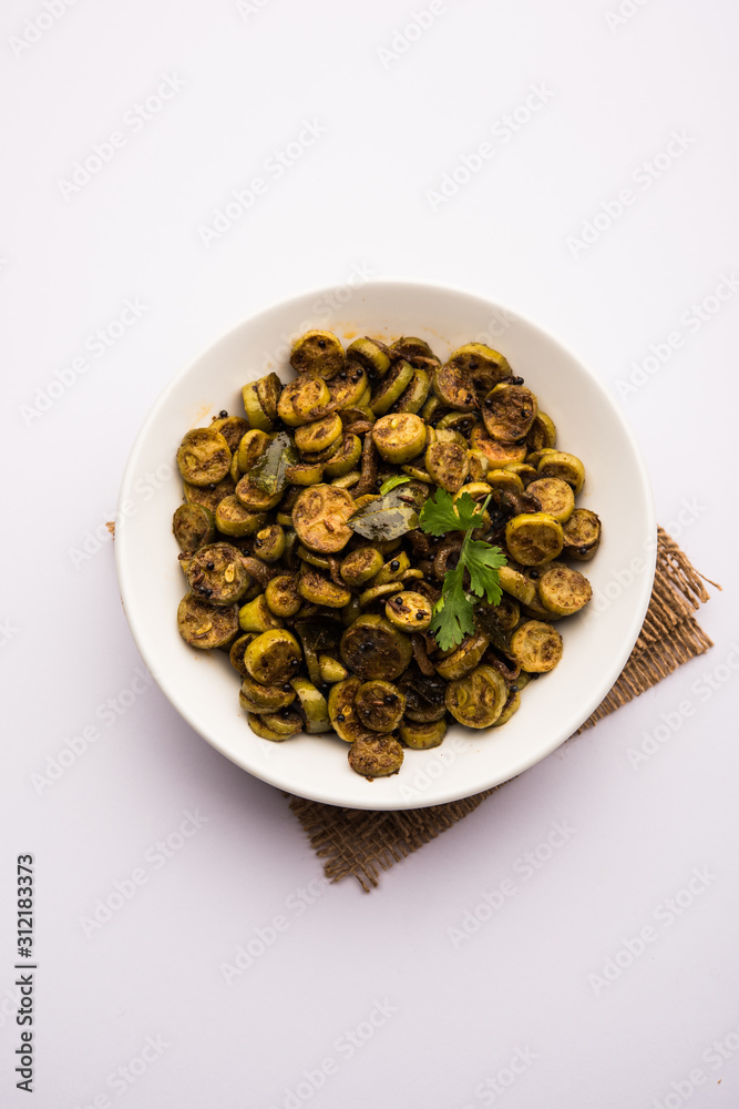 Tendli / Kundroo sabzi or Kovakkai Poriyal also known as ivy gourd, served in a bowl or karahi. selective focus Tendli / Kundroo sabzi or Kovakkai Poriyal also known as ivy gourd, served in a bowl or karahi. selective focus