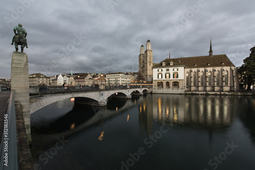 zurich switzerland, old town with the historic buildings and churches on the limmat river in the evening in the christmas time.