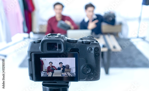 2 Asian young man blogger present and review product video broadcast live stream video to a social network. blogging, video blog, vlogging, online shopping, and social media concept © K-MookPan