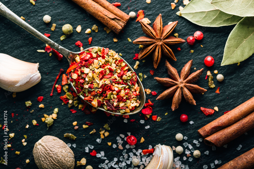 Mix of spices on a dark background, seasoning for cooking