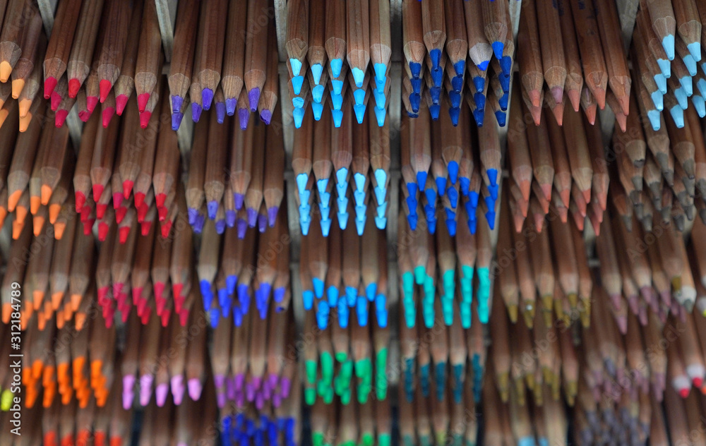Pencils at the stationery showcase. Colorful pencils for drawing and graphic arts. Drawing education background.