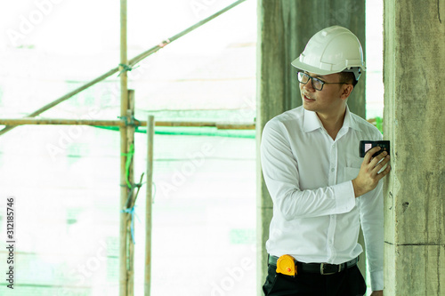 Inspector checking distance of pole in construction site