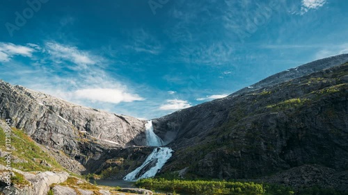 Kinsarvik, Hordaland, Norway. Waterfall Nykkjesoyfossen In Hardangervidda Mountain Plateau. Spring Sunny Day. Height Of 49 m. Famous Norwegian Landmark And Popular Destination. 4K photo