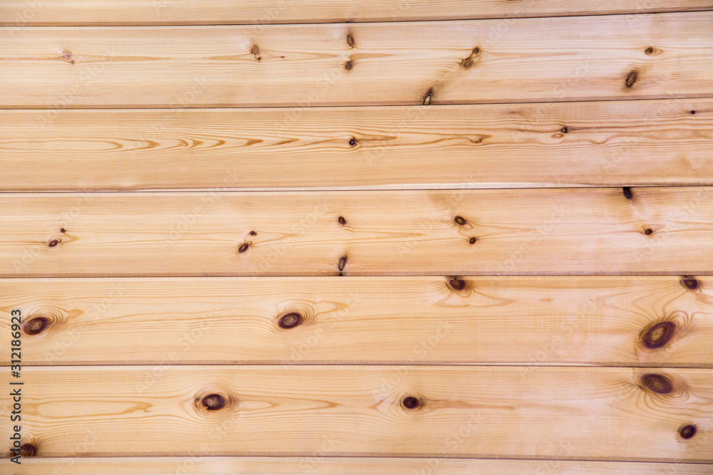 Obraz premium Background of planed boards of coniferous species under the imitation of a bar, with a beautiful pattern of the structure of trees with knots. Design backgrounds texture construction.