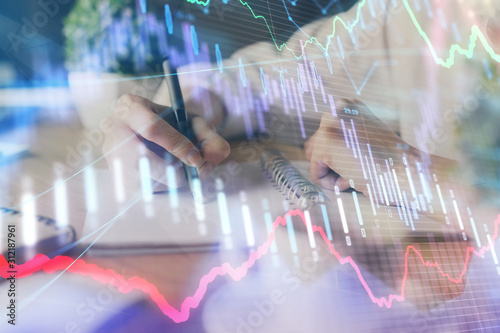 Wallpaper Mural Financial forex graph displayed on hands taking notes background. Concept of research. Double exposure Torontodigital.ca