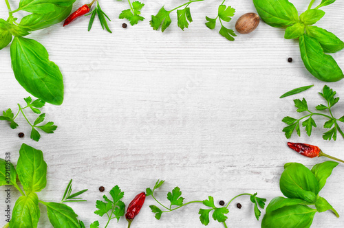 Fresh spices on wooden background top view.