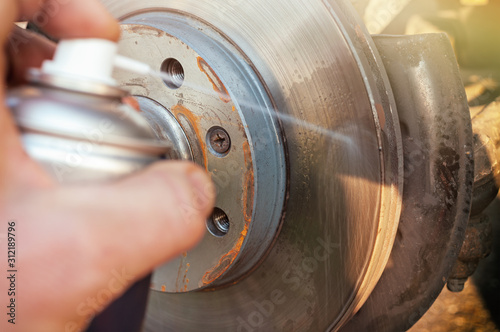 Obraz na płótnie Car disk brake cleaning with spray. w salonie
