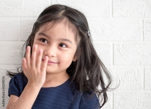 Fashion model and beauty look. Stylish girl with pretty face on grey background. Hairdresser  skincare  casual style. Beauty and kid fashion with healthy hair. Little girl with long hair.