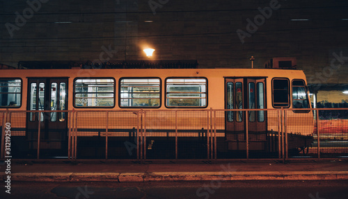 A train standing at a small roofless train station