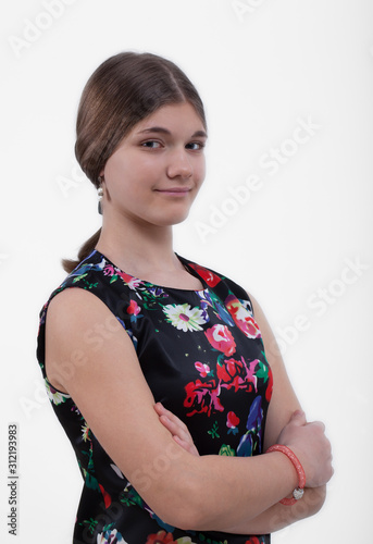 Smiling girl with smoothly combed hair in a summer dress on a white background