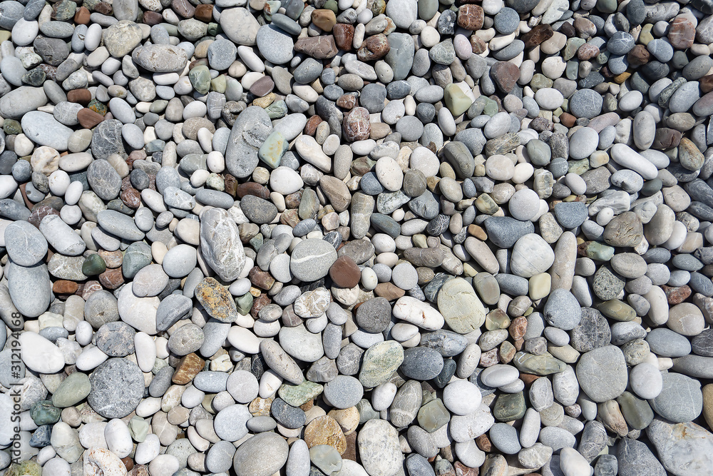 many pebbles lie on the beach. Pattern of small stones many pebbles lie on the beach. Pattern of small stones